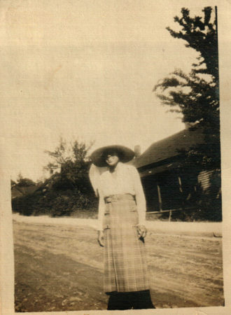 Unknown Black woman in a hat and dress