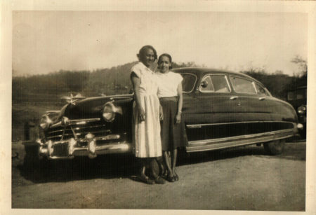 Emma Stewart England and Bessie Jackson posing near car