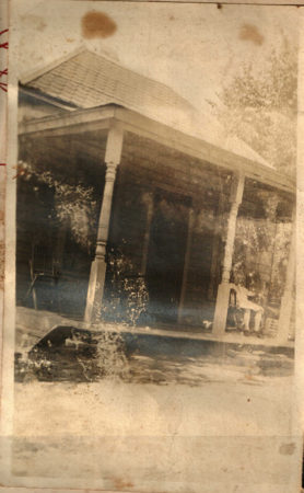 Old house with person sitting on porch
