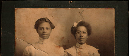 Black women with hair bows posing