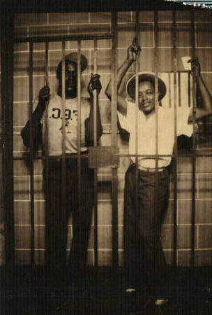 Friend and Gus England posing in fake jail